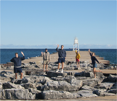 The Curley family on a breakwall in Munising